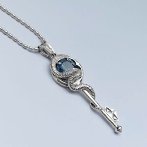 Llave serpiente · Dije plata 950 y piedra